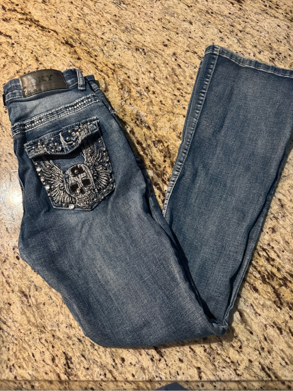 Sky Jeans - Embellished Blue Jeans with Winged Skull Pocket